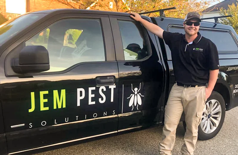 JEM Pest Solutions Owner standing next to truck
