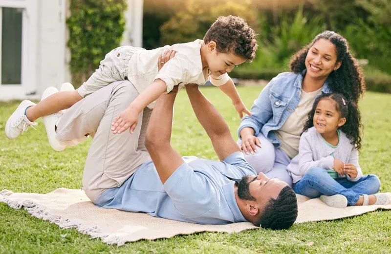 family playing outside mosquito free yard